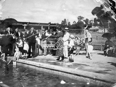 Photograph, Eltham - Late Crs. Braid (left) and Kirkland cut the ribbon at the opening ceremony of swimming pool, 19 December 1936, 19 Dec 1936