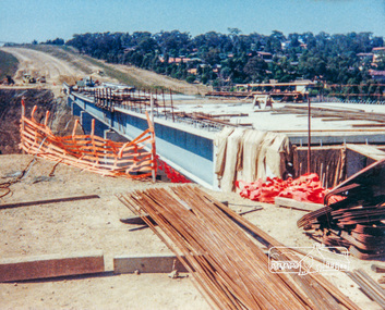 Photograph, Looking east across the new bridge construction across the Plenty River from the western side up to the new roundabout at Civic Drive; Greensborough Bypass construction, c.1986, 1986c