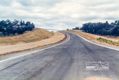 Photograph, Looking east from the new bridge towards the newly completed pedestrian overpass and the roundabout at the end of the Bypass at Civic Drive; Greensborough Bypass construction, c.1986, 1986c