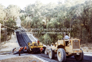 Photograph, Putting on the bitumen, bottom of the 'Big Dipper', road construction, Ryans Road, Eltham North, 1983, 1983