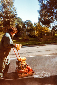 Photograph, Compacting bitumen on driveway crossing, road construction, Ryans Road, Eltham North, 1983, 1983