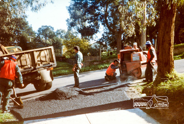 Photograph, Laying the bitumen for entrance crossing, road construction, Ryans Road, Eltham North, 1983