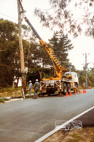 Photograph, Repairs to State Electricity Commission pole, road construction, Ryans Road, Eltham North, 1983