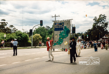 Photograph, Russell Yeoman (left) and Joh Ebeli carry the Shire of Eltham Historical Society's new banner in front of the Society's Parade entry, Eltham Community Festival Parade, 8 November 1986, 08/11/1986