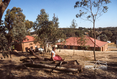 Photograph, Backyard, Carla Vermey on logs, April 1980