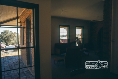 Photograph, Carla Vermey in living room from dining room, April 1980