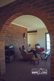 Photograph, Peter and Carla Vermey in living room from entry hall, April 1980