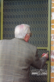 Photograph, Peter Bassett-Smith tuns the key, 12 July 1998, 12/07/1998