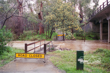 Negative - Photograph, Harry Gilham, Diamond Creek flooding over the Main Road footbridge, Eltham, c.Aug. 1996