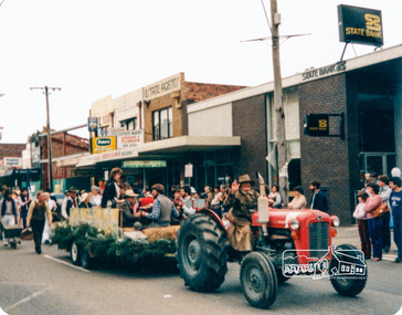 Photograph, Society member Peter Bassett-Smith towing the Shire of Eltham Historical Society float with his tractor in the Eltham Festival Parade along Main Road, 16 October 1982, 16/10/1982