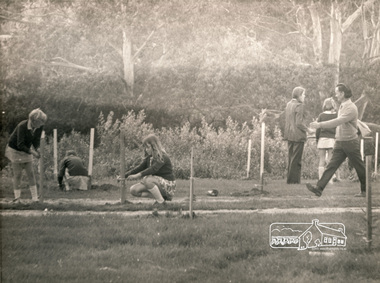 Photograph, ELTHAM ARBOR DAY 1973 - Alistair Knox with school children of the Shire of Eltham, Vic, planting native trees in the Town Park, 10 October 1973, 1973-10-10