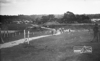 Photograph, ELTHAM ARBOR DAY 1973 - Alistair Knox with school children of the Shire of Eltham, Vic, planting native trees in the Town Park, 10 October 1973, 1973-10-10