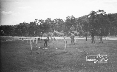 Photograph, ELTHAM ARBOR DAY 1973 - Alistair Knox with school children of the Shire of Eltham, Vic, planting native trees in the Town Park, 10 October 1973, 1973-10-10