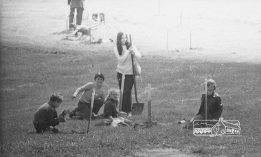 Photograph, ELTHAM ARBOR DAY 1973 - Alistair Knox with school children of the Shire of Eltham, Vic, planting native trees in the Town Park, 10 October 1973, 1973-10-10