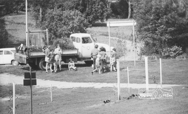 Photograph, ELTHAM ARBOR DAY 1973 - Alistair Knox with school children of the Shire of Eltham, Vic, planting native trees in the Town Park, 10 October 1973, 1973-10-10