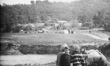Photograph, ELTHAM ARBOR DAY 1973 - Alistair Knox with school children of the Shire of Eltham, Vic, planting native trees in the Town Park, 10 October 1973, 1973-10-10