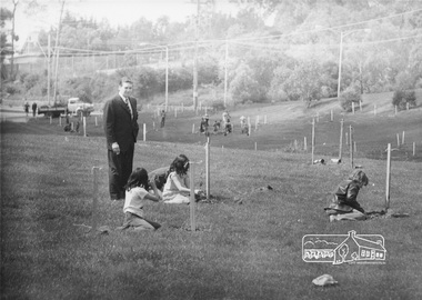 Photograph, ELTHAM ARBOR DAY 1973 - Alistair Knox with school children of the Shire of Eltham, Vic, planting native trees in the Town Park, 10 October 1973, 1973-10-10