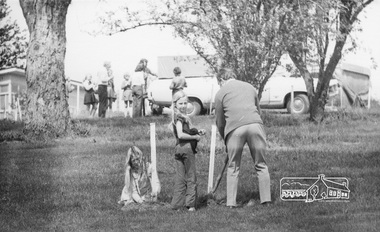 Photograph, ELTHAM ARBOR DAY 1973 - Alistair Knox with school children of the Shire of Eltham, Vic, planting native trees in the Town Park, 10 October 1973, 1973-10-10