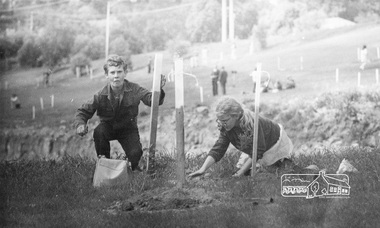 Photograph, ELTHAM ARBOR DAY 1973 - Alistair Knox with school children of the Shire of Eltham, Vic, planting native trees in the Town Park, 10 October 1973, 1973-10-10