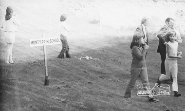 Photograph, ELTHAM ARBOR DAY 1973 - Alistair Knox with school children of the Shire of Eltham, Vic, planting native trees in the Town Park, 10 October 1973, 1973-10-10