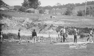 Photograph, ELTHAM ARBOR DAY 1973 - Alistair Knox with school children of the Shire of Eltham, Vic, planting native trees in the Town Park, 10 October 1973, 1973-10-10