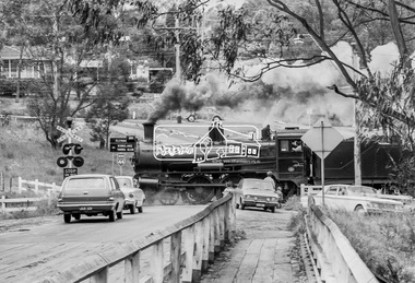 Photograph, Steam locomotive D639 with Tait (Red Rattler) carriages passing through the level crossing at Wattletree Road, Eltham bound for Hurstbridge, c.1970, 1970
