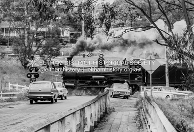 Photograph, Steam locomotive D639 with Tait (Red Rattler) carriages passing through the level crossing at Wattletree Road, Eltham bound for Hurstbridge, c.1970