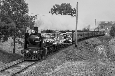 Photograph, George Coop, Vintage train excursion hauled by steam locomotive K-190 en route to Hurstbridge near the level crossing at Allendale Road, Eltham, 3 July 1983, 1983