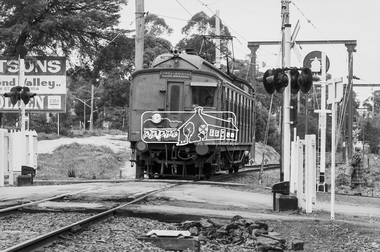 Photograph, George Coop, Hurstbridge bound Tait (Red Rattler) motor carriage passing through the level crossing at Diamond Street, Eltham, 17 July 1983, 1983