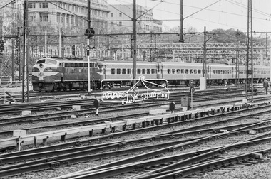 Photograph, George Coop, B-class diesel etric locomotive B70 with passenger cars at Flinders Street Railway Yard, 22 August 1983, 1983
