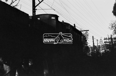Photograph, A Melbourne bound B Class Diesel-Electric Locomotive silhouetted as it crosses the Eltham Railway Trestle Bridge, c.1983, 1983
