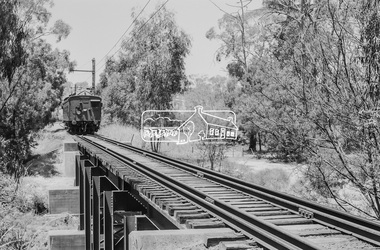 Photograph, George Coop, Single Motor Carriage (Red Rattler) Tait train heading for Hurstbridge about to cross over the Diamond Creek just north of Allendale Road, c.December 1980, 1980
