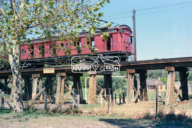 Photograph, George Coop, Tait Single Motor Carriage 317M (Red Rattler) train passes over the Eltham Railway Trestle Bridge, c. March 1981, c. March 1981