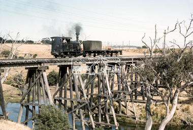 Photograph, No. 6 locomotive, a Hudswell Clarke  0-4-2SToc locomotive crossing the railway trestle bridge over the Mooroobool River,  Fyansford Cement Works Railway, November 1962, 1962