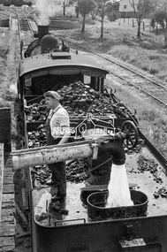 Photograph, Steam locomotive K-158 filling up with water at the coal hopper, Echuca Railway Station, November 1963, 1963