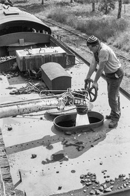 Photograph, Steam locomotive R-727 being filled with water at the coal hopper, Echuca Railway Station, November 1963, 1963