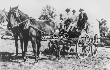 Photograph, View of two men wearing hats with a young woman seated in between on a cart harnessed to two horses, possibly Diamond Creek and Hurstbridge district, c.1920