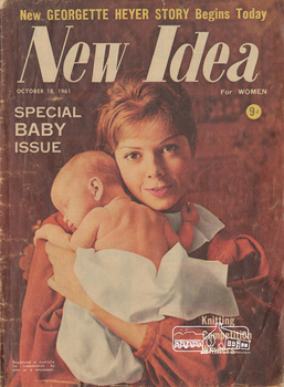 Cover of magazine with colour photograph of young woman holding a sleeping baby over her shoulder