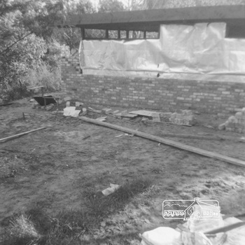 External corner of the house with wrapping around windows as brick work is completed