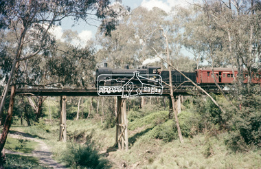 Slide - Photograph, Russell Yeoman, Steam engine K-184 hauling a special excursion train across the Eltham Railway Trestle Bridge, c.1974