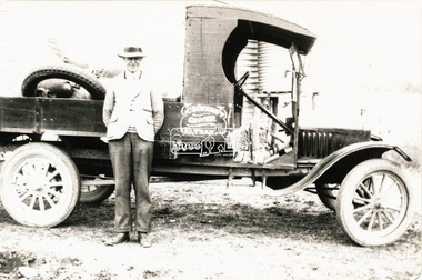 Photograph, Charles Cockcroft, Grocer, Eltham, beside his delivery truck, c.1935