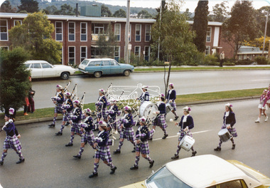 Photograph, Joan Castledine, St Andrews Ladies Pipe Band marching past the Eltham Shire Offices during 'Eltham Week' celebrations, Aug. 1976