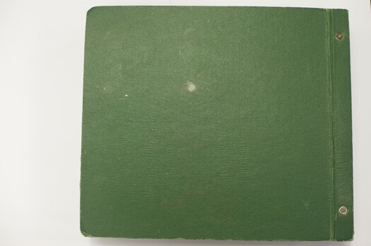 Large book of photographs in hard green cover