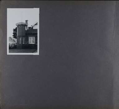 1 photo on page - view of mainly a tower, part of a large brick home