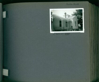 One photo on page - old wooden house with verandah at front and tower behind.