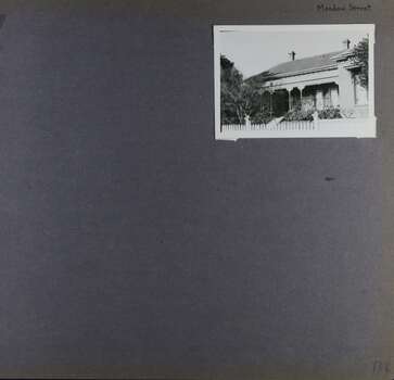 One photo of an old house with a verandah in its garden.