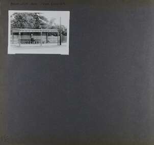 1 photo of an old timber shelter with long seat