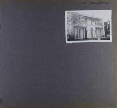 View of front of large 2 storey house with arches in verandah and balcony