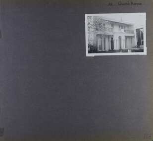 View of front of large 2 storey house with arches in verandah and balcony