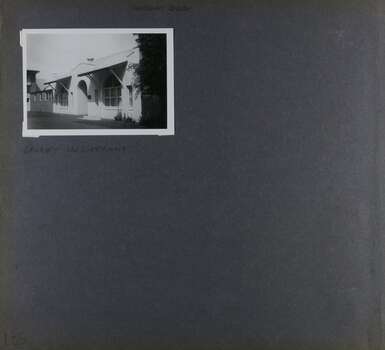 1 photo with view of single storey white building with arched doorway entrance.  Other buildings may join up to it. 